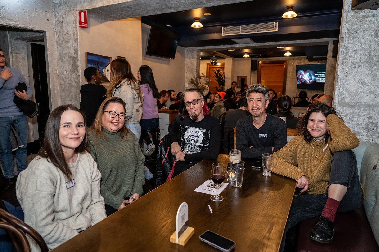 Guests smiling around a table